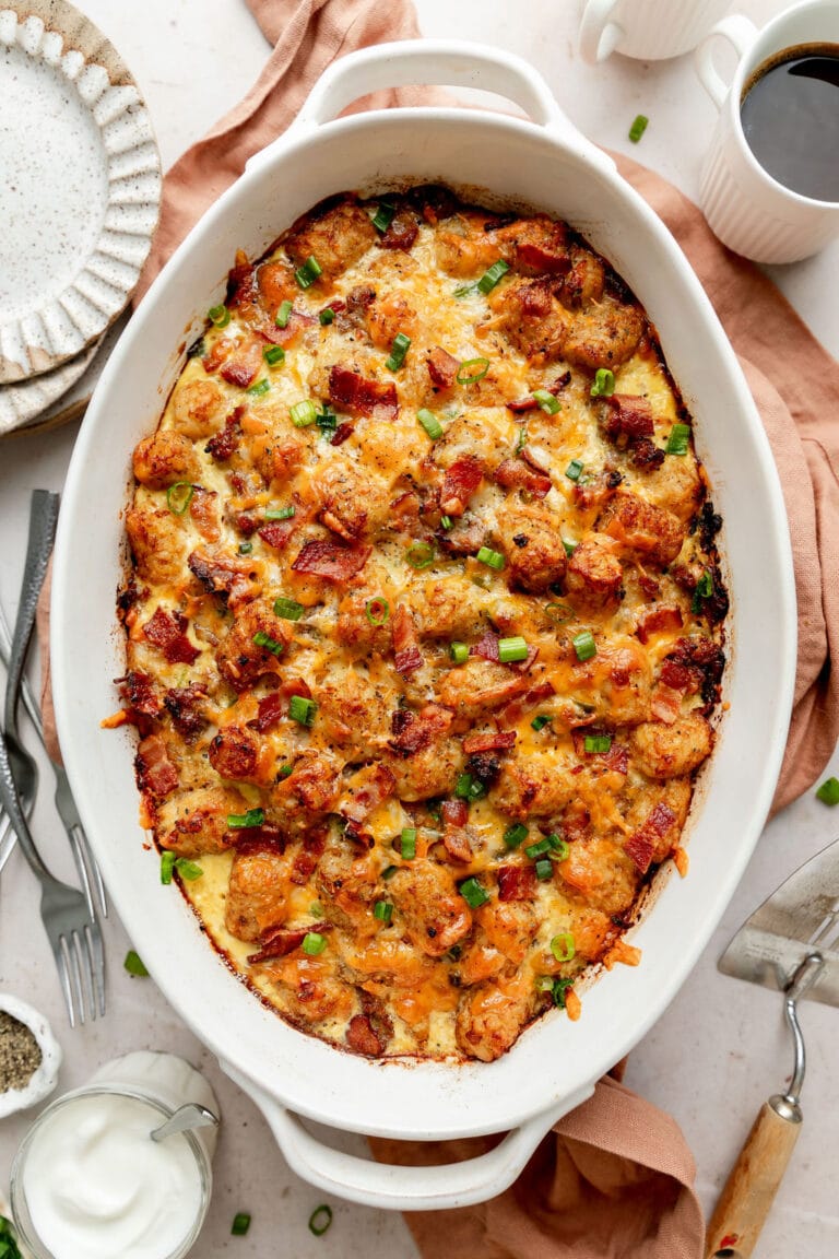 Overhead view of a freshly baked pan of tater tot breakfast casserole topped with green onions. 